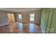 Large open concept living room with hardwood floors and windows at 401 Pamela St, Gastonia, NC 28054