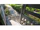 View from a wooden porch overlooking a tree-lined street and lush greenery at 401 Pamela St, Gastonia, NC 28054