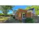 The side yard features brick exterior and lush greenery, complemented by mature trees at 401 Pamela St, Gastonia, NC 28054