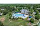 Stunning aerial view of community pool, clubhouse, water slide, playground, and sports fields at 4028 Woodsmill Rd, Fort Mill, SC 29707