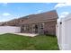 A spacious backyard with patio, grassy area, white fence and brick exterior at 4028 Woodsmill Rd, Fort Mill, SC 29707