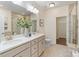 Bright bathroom features double vanity with stone countertops, and tiled shower and floors at 4028 Woodsmill Rd, Fort Mill, SC 29707