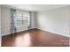 Bedroom featuring hardwood floors, a window with curtains, and neutral paint at 4028 Woodsmill Rd, Fort Mill, SC 29707