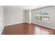 The bedroom has hardwood floors, a window with blinds, and light gray walls at 4028 Woodsmill Rd, Fort Mill, SC 29707