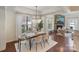 Bright dining room with a decorative chandelier, large windows, and hardwood floors at 4028 Woodsmill Rd, Fort Mill, SC 29707