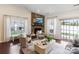 Cozy living room with stone fireplace, large windows, and patio access at 4028 Woodsmill Rd, Fort Mill, SC 29707