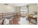 The upstairs loft area has natural light, and wood floors leading into the staircase at 4028 Woodsmill Rd, Fort Mill, SC 29707
