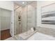 Modern bathroom shower with glass enclosure, tiled walls, and built-in shelving at 4028 Woodsmill Rd, Fort Mill, SC 29707
