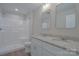 Bright bathroom features a double sink vanity with granite countertops and a shower at 407 Chambers St, Statesville, NC 28677
