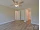 Comfortable bedroom with ceiling fan and access to an attached bathroom with a shower at 407 Chambers St, Statesville, NC 28677