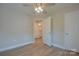 Bright bedroom has access to an attached bathroom, modern ceiling fan and vinyl floors at 407 Chambers St, Statesville, NC 28677