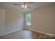 Well-lit bedroom with a window, ceiling fan, and neutral décor at 407 Chambers St, Statesville, NC 28677