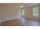 This bedroom offers natural light, a ceiling fan, and stylish laminate floors at 407 Chambers St, Statesville, NC 28677