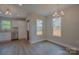 Dining area with new laminate flooring, chandelier, and lots of natural light at 407 Chambers St, Statesville, NC 28677