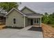 Charming home with light green vinyl siding, black roof, and freshly landscaped front yard at 407 Chambers St, Statesville, NC 28677