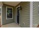 Home entry featuring black front door and light green vinyl siding at 407 Chambers St, Statesville, NC 28677
