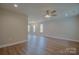 Spacious living room with laminate floors, ceiling fan, and neutral color scheme at 407 Chambers St, Statesville, NC 28677