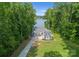 An aerial view of a waterfront property featuring a long driveway and mature trees at 434 Breezewood Dr, Belmont, NC 28012