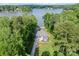 An aerial view of a waterfront property featuring a house nestled among trees at 434 Breezewood Dr, Belmont, NC 28012