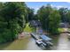 A unique aerial view showcases the home, boat dock and lift, and surrounding landscape at 434 Breezewood Dr, Belmont, NC 28012