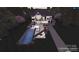 Aerial view of an inground pool featuring a lounge area and manicured backyard at 434 Breezewood Dr, Belmont, NC 28012