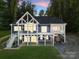 Beautiful two-story home featuring a large, covered deck and patio at 434 Breezewood Dr, Belmont, NC 28012