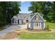 Charming two-story home featuring a landscaped yard and a long driveway at 434 Breezewood Dr, Belmont, NC 28012