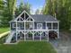 Beautiful two-story home with multiple decks, a spacious yard, and wooded surroundings at 434 Breezewood Dr, Belmont, NC 28012