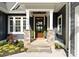 Inviting front entrance featuring stone accents, dark siding, and manicured landscaping at 434 Breezewood Dr, Belmont, NC 28012