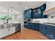 Bright kitchen with white countertops, stainless steel appliances, and navy blue cabinets at 434 Breezewood Dr, Belmont, NC 28012