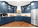 Stylish kitchen features custom blue cabinetry, stainless steel appliances, and ample counter space at 434 Breezewood Dr, Belmont, NC 28012