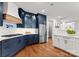 Beautiful kitchen featuring navy cabinets, stainless steel appliances, and hardwood floors at 434 Breezewood Dr, Belmont, NC 28012