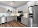 Well-lit kitchen features stainless steel appliances, light cabinets, and modern fixtures at 434 Breezewood Dr, Belmont, NC 28012