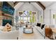 Bright living room boasts a stone fireplace, soaring ceilings, and lake views through expansive windows at 434 Breezewood Dr, Belmont, NC 28012