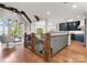 Open-concept living space with hardwood floors leading to gourmet kitchen and adjacent sitting areas at 434 Breezewood Dr, Belmont, NC 28012