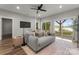 Open living room with modern furniture, ceiling fan and bright natural light at 434 Breezewood Dr, Belmont, NC 28012