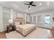 Bedroom features a plush bed, tray ceilings, and views of the water at 434 Breezewood Dr, Belmont, NC 28012