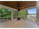 View of screened in porch with outdoor fireplace and serene lake view at 434 Breezewood Dr, Belmont, NC 28012