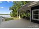 Spacious covered patio with outdoor seating overlooking a serene lake at 434 Breezewood Dr, Belmont, NC 28012