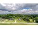 Aerial view of two houses with large lawns, bordered by lush trees and a nearby street at 4470 W Bandys Cross Rd, Claremont, NC 28610