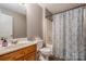 Bathroom features a classic design with a wood vanity and combined shower and tub at 4470 W Bandys Cross Rd, Claremont, NC 28610