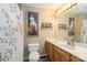 Bathroom with a wooden vanity, toilet, and bathtub with shower, decorated with framed art at 4470 W Bandys Cross Rd, Claremont, NC 28610