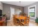 Cozy dining room featuring a wooden table and chairs, plus backyard views at 4470 W Bandys Cross Rd, Claremont, NC 28610
