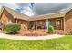 Inviting front porch with brick accents, decorative shrubbery, and comfortable seating at 4470 W Bandys Cross Rd, Claremont, NC 28610