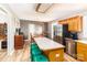 Open-concept kitchen with stainless steel appliances, island seating, and wooden cabinets at 4470 W Bandys Cross Rd, Claremont, NC 28610