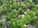 Aerial view showcasing a house surrounded by lush green trees in a residential neighborhood at 5900 Colwick Nw Ct, Concord, NC 28027
