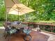 Enjoyable back deck with dining table, mature trees, and comfortable seating at 5900 Colwick Nw Ct, Concord, NC 28027
