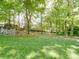 Manicured backyard, with lush green grass and mature trees, offering a serene outdoor space at 5900 Colwick Nw Ct, Concord, NC 28027