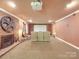 Finished basement with projector screen and decorative fireplace at 5900 Colwick Nw Ct, Concord, NC 28027