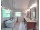 Bright bathroom featuring a soaking tub, glass-enclosed shower, and double vanity at 5900 Colwick Nw Ct, Concord, NC 28027